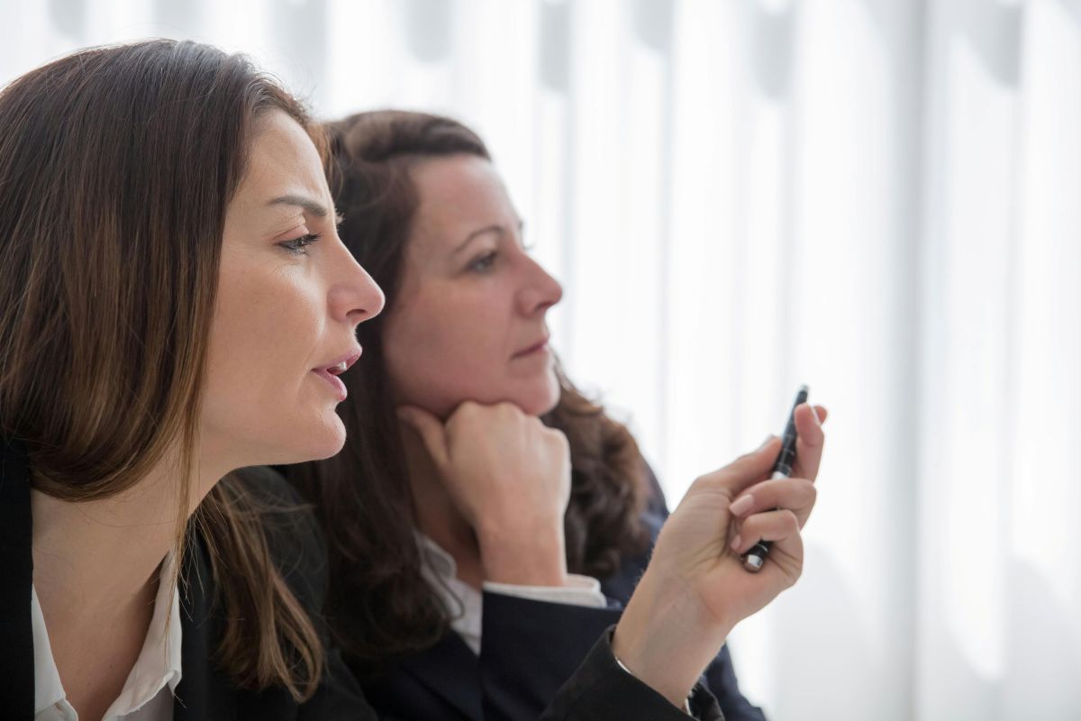 Deux femmes en situation d’écoute dans une réunion professionnelle, illustration de la communication relationnelle.